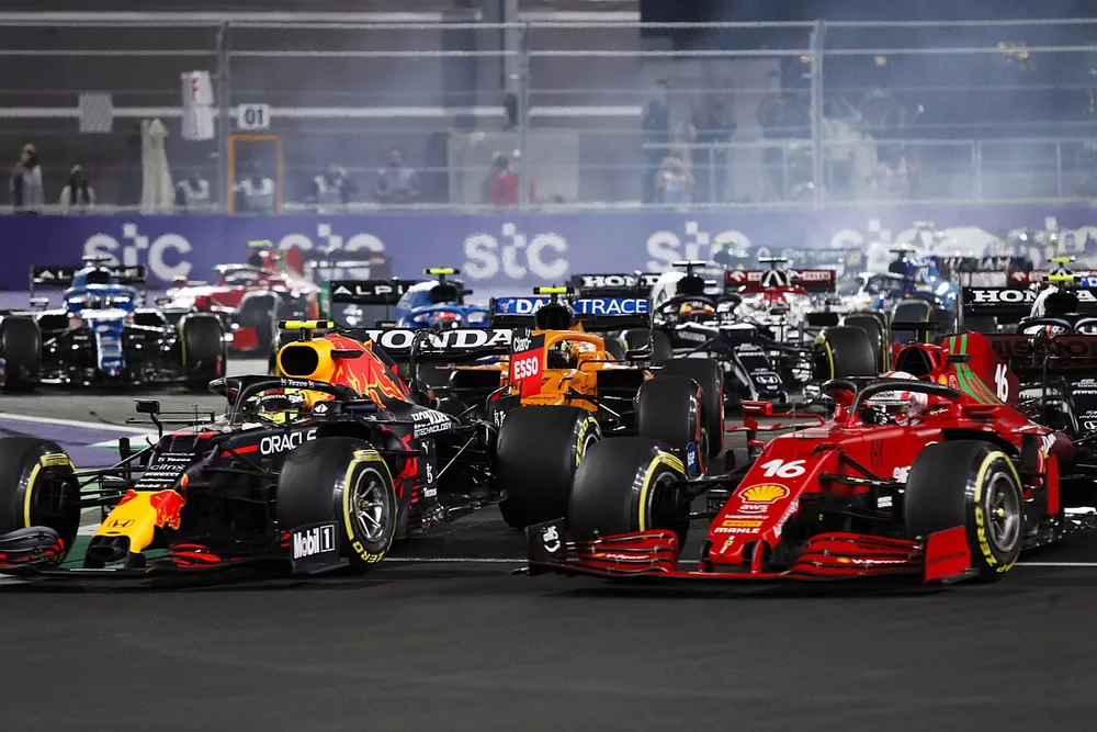 Sergio Perez, Red Bull Racing RB16B, Charles Leclerc, Ferrari SF21, and Lando Norris, McLaren MCL35M, at the restart