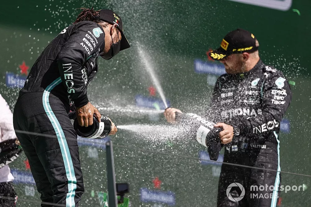 Lewis Hamilton, Mercedes, 1st position, and Valtteri Bottas, Mercedes, 3rd position, spray Champagne on the podium