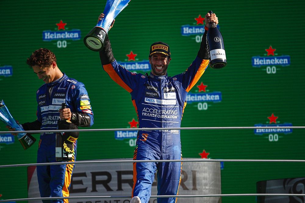 Daniel Ricciardo, McLaren, 1st position, celebrates on the podium with his trophy with his trophy and Champagne