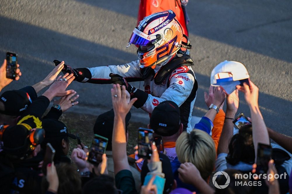 Nico Hulkenberg, Haas F1 Team, high fives some fans after stopping at the end of the race