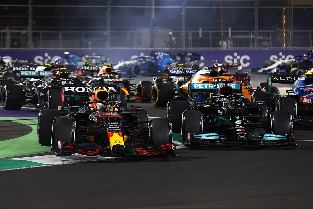 Max Verstappen, Red Bull Racing RB16B, runs off the track while battling with Lewis Hamilton, Mercedes W12 at the restart
