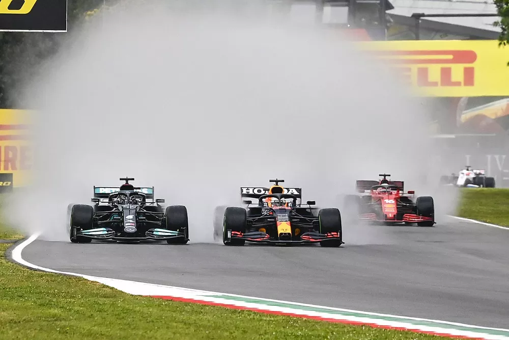 Lewis Hamilton, Mercedes W12 and Max Verstappen, Red Bull Racing RB16B battle at the start of the race