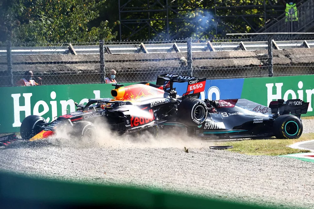 Max Verstappen, Red Bull Racing RB16B, and Lewis Hamilton, Mercedes W12, collide whilst battling for position