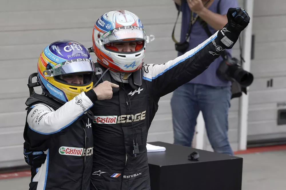 Fernando Alonso, Alpine F1, celebrates with Esteban Ocon, Alpine F1, 1st position, in Parc Ferme