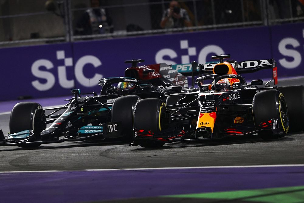 Max Verstappen, Red Bull Racing RB16B, and Lewis Hamilton, Mercedes W12, make contact as they battle for the lead