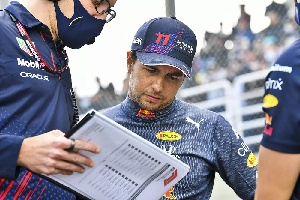 Sergio Perez, Red Bull Racing, on the grid with an engineer