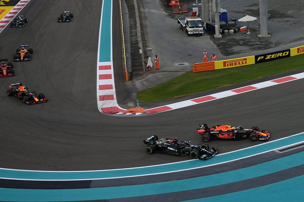 Max Verstappen, Red Bull Racing RB16B, battles with Lewis Hamilton, Mercedes W12, on the opening lap
