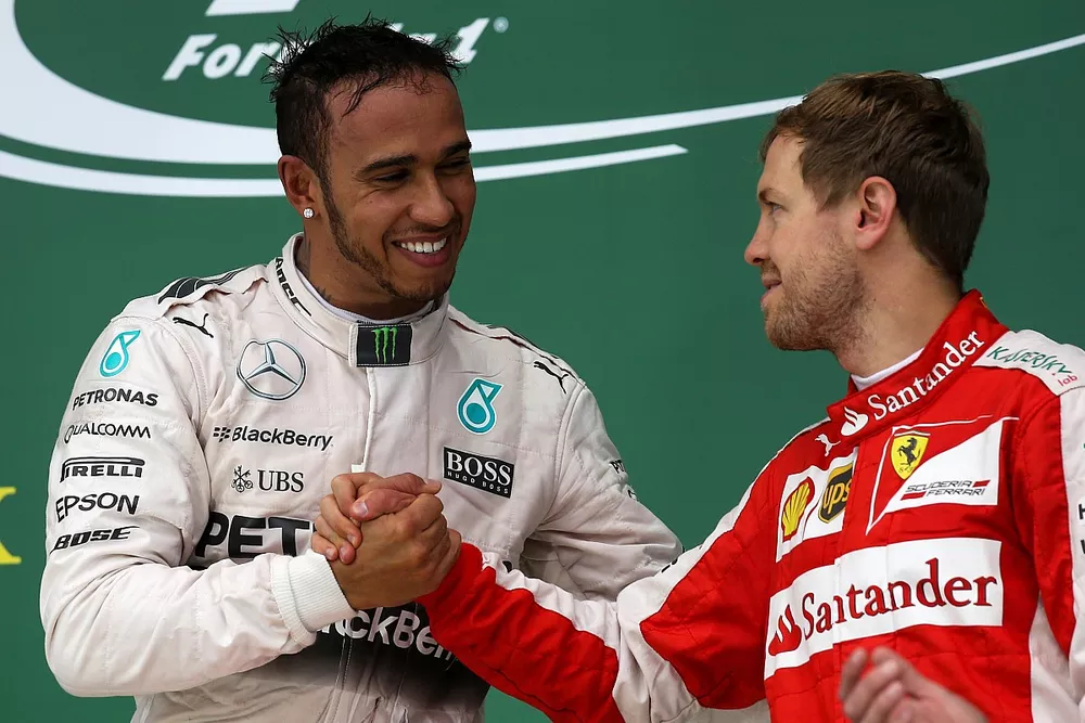 Lewis Hamilton is congratulated by Sebastian Vettel after clinching his third world title