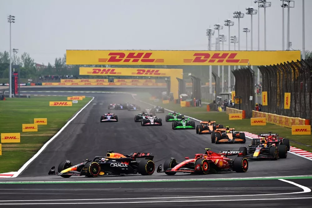 Max Verstappen, Red Bull Racing RB20 battles with Carlos Sainz, Ferrari SF-24 