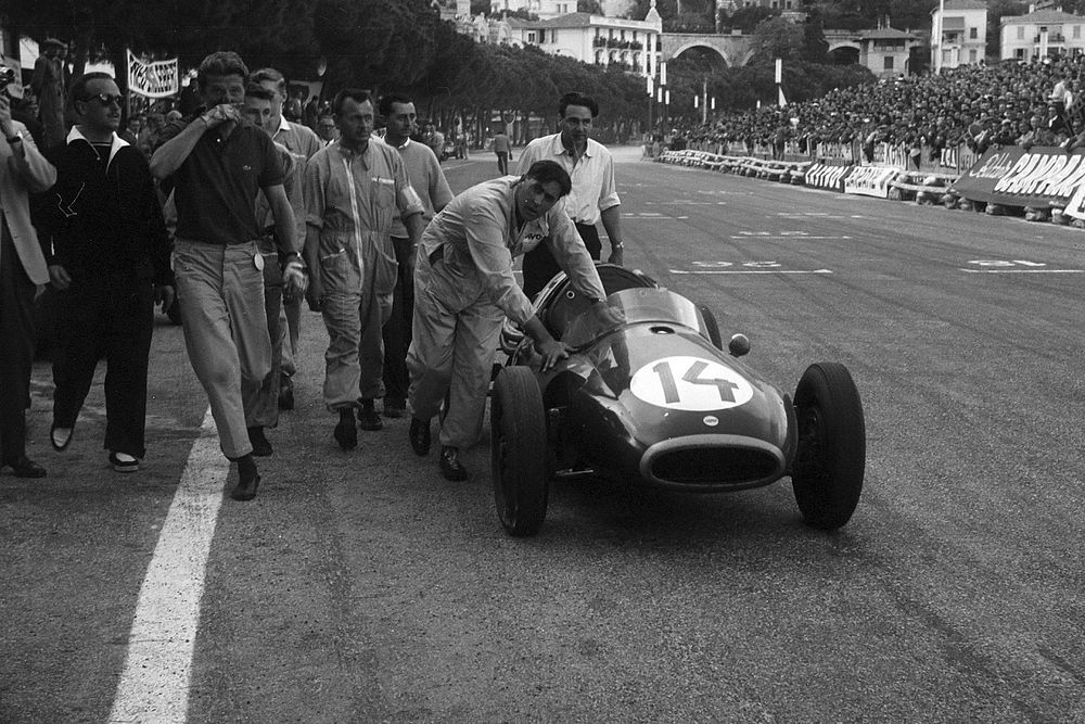 Jack Brabham pushes his Cooper T43 Climax across the line