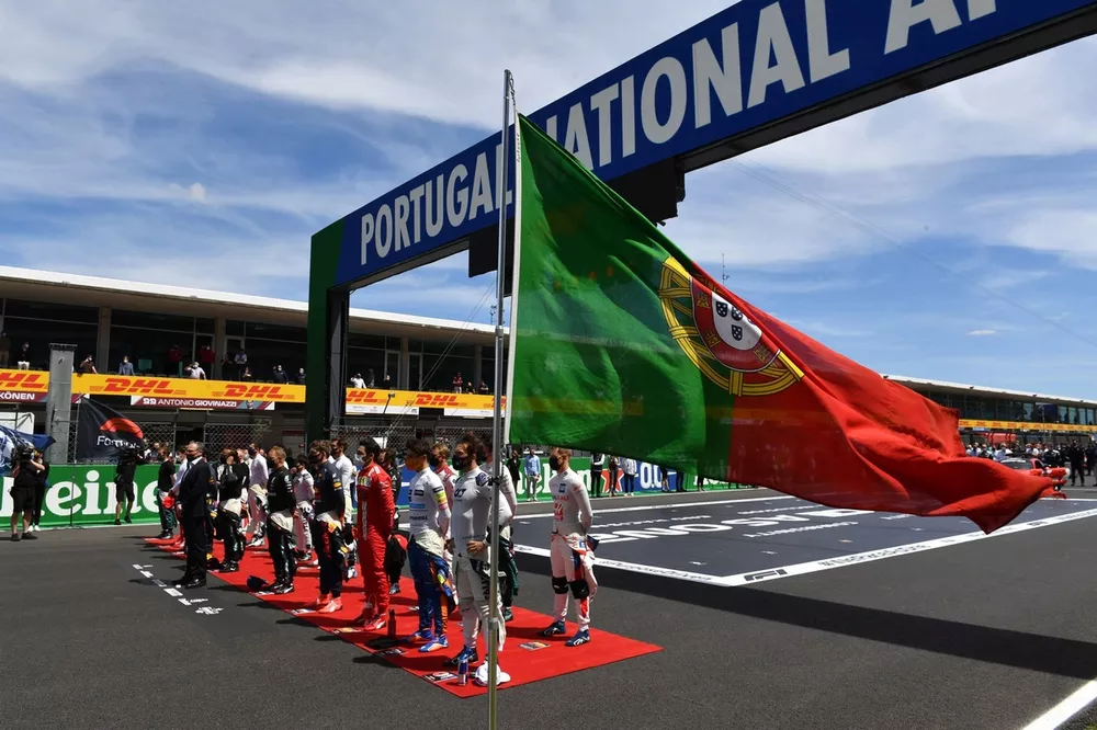 The drivers stand on the grid for the national anthem prior to the start