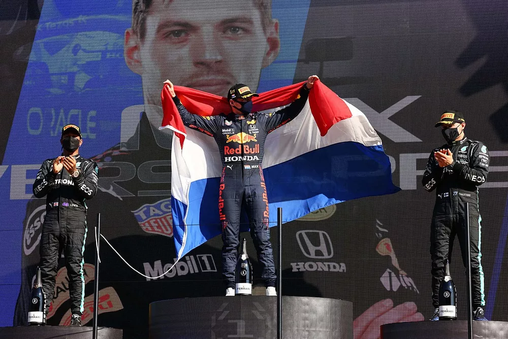 Lewis Hamilton, Mercedes, 2nd position, Max Verstappen, Red Bull Racing, 1st position, and Valtteri Bottas, Mercedes, 3rd position, celebrate on the podium