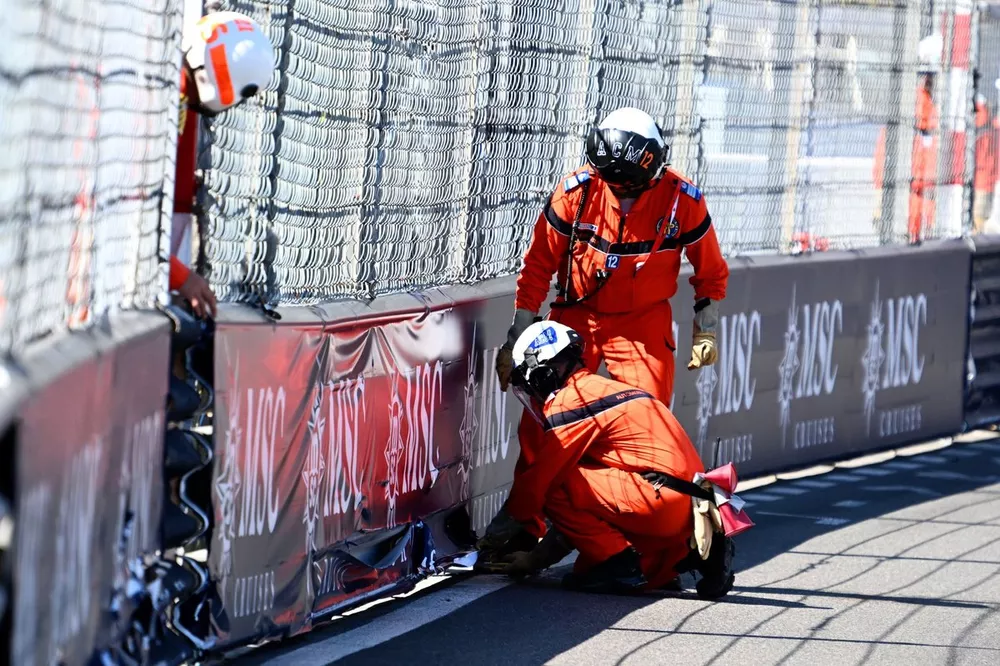 Marshals repair some trackside advertising