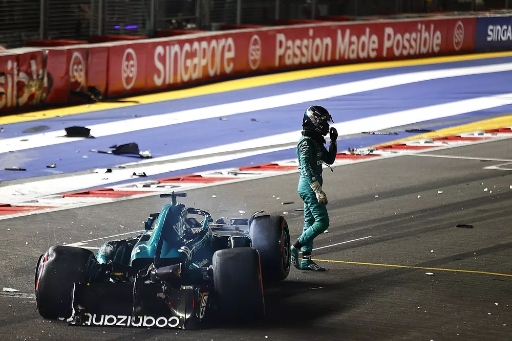 Lance Stroll, Aston Martin AMR23, walks away from his heavily damaged car after a crash towards the end of Q1
