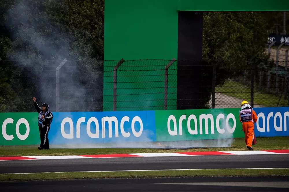 Marshals rush to put out the fire on the grass