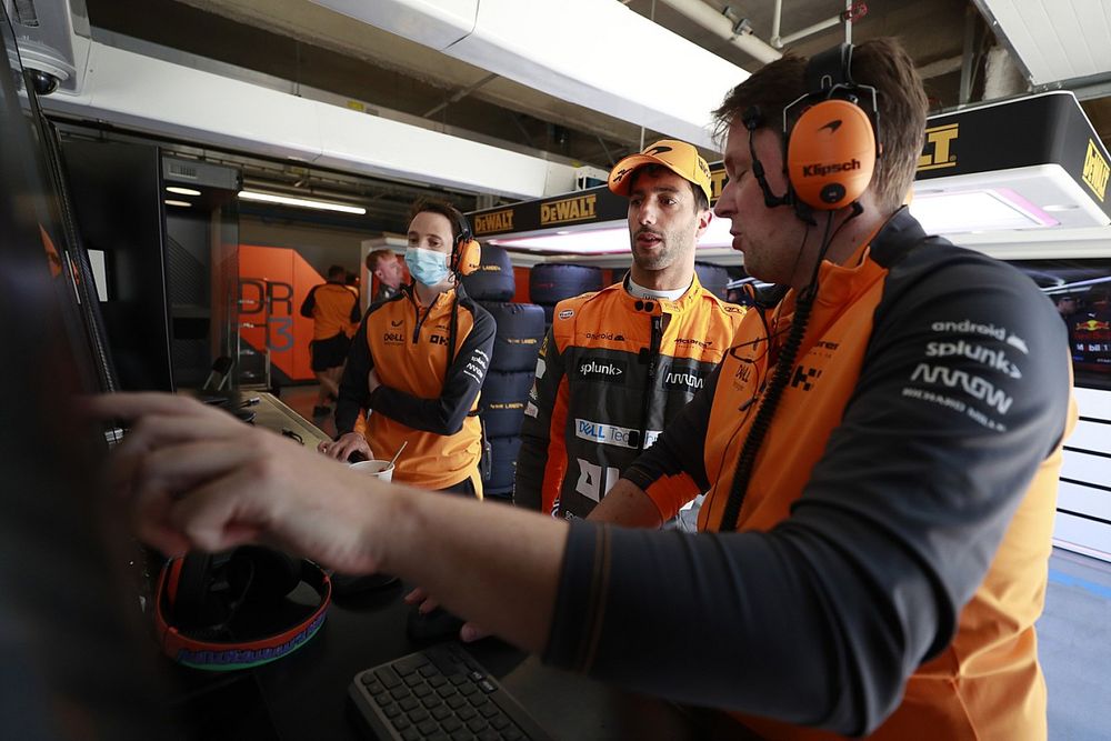 Daniel Ricciardo, McLaren, in the garage with engineers