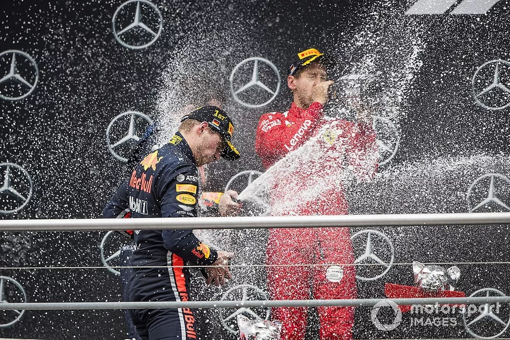 Race winner Max Verstappen, Red Bull Racing and Sebastian Vettel, Ferrari celebrates on the podium with the champagne