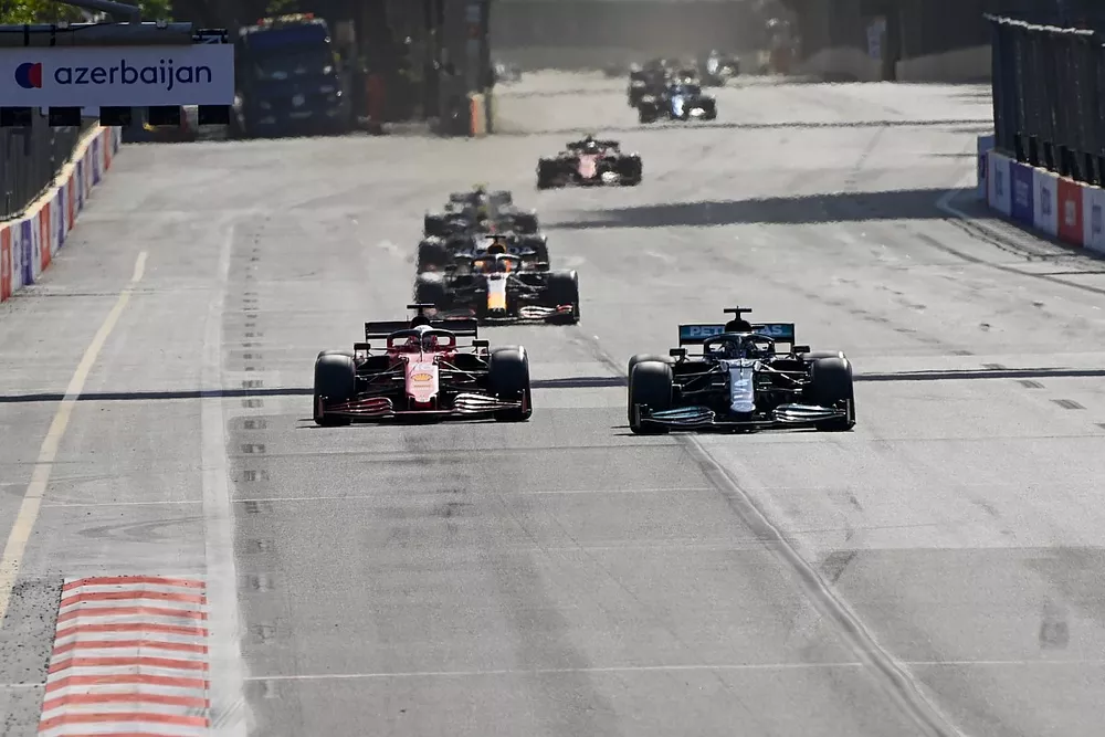 Lewis Hamilton, Mercedes W12, passes Charles Leclerc, Ferrari SF21