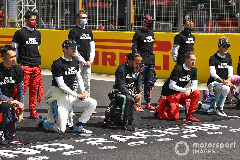 Lewis Hamilton, Mercedes-AMG F1, and the other drivers stand and take a knee to show their support for the End Racism campaign