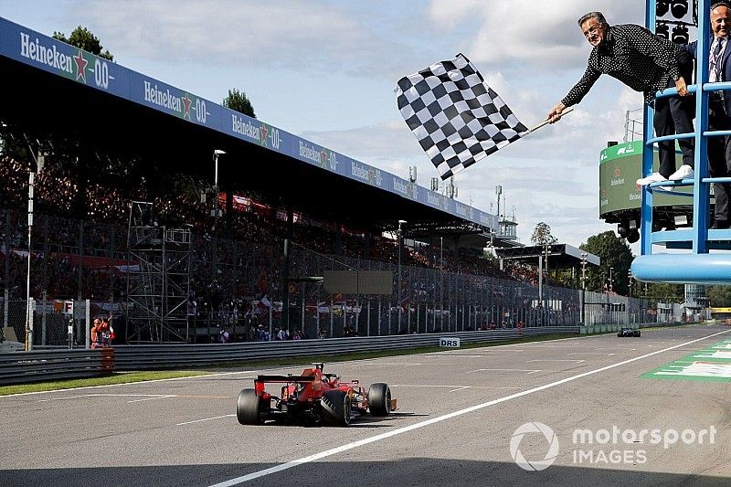 Race Winner Charles Leclerc, Ferrari SF90 crosses the finish line with Jean Alesi waving the chequered flag 