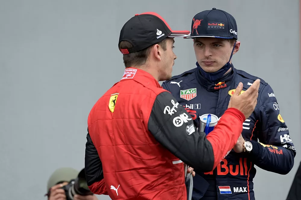 Charles Leclerc, Ferrari, talks with pole man Max Verstappen, Red Bull Racing