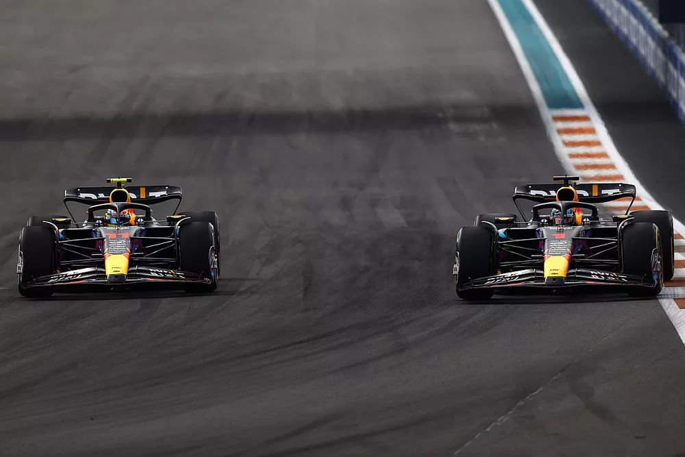 Max Verstappen, Red Bull Racing RB19, passes Sergio Perez, Red Bull Racing RB19, for the lead