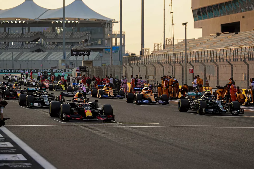 Max Verstappen, Red Bull Racing RB16, Valtteri Bottas, Mercedes F1 W11, Lewis Hamilton, Mercedes F1 W11, and Lando Norris, McLaren MCL35, prepare to lead the field away as mechanics clear the grid