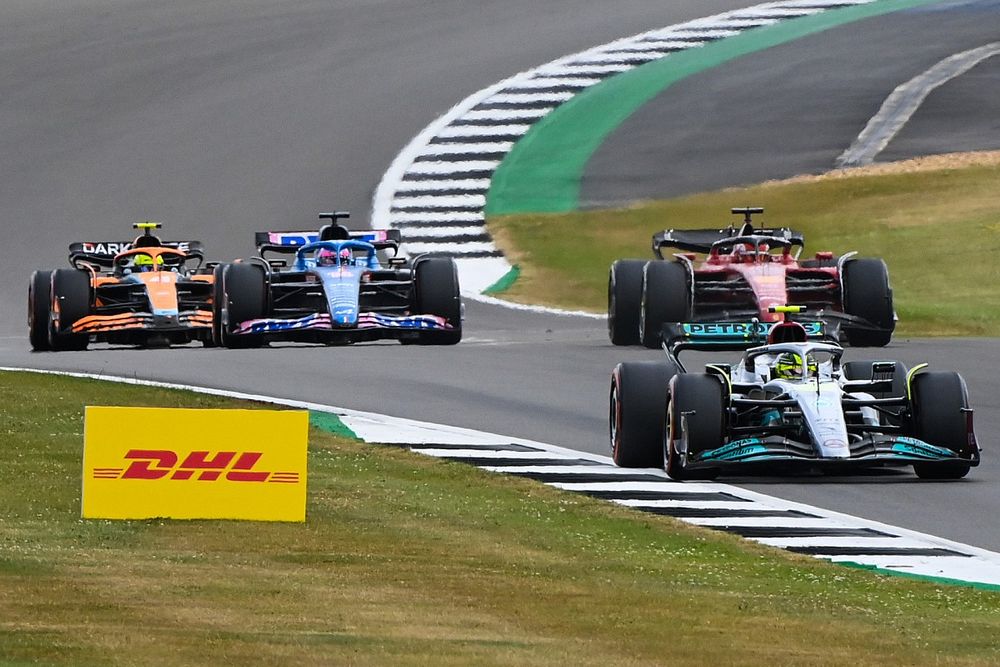 Lewis Hamilton, Mercedes W13, leads Charles Leclerc, Ferrari F1-75, Fernando Alonso, Alpine A522, and Lando Norris, McLaren MCL36