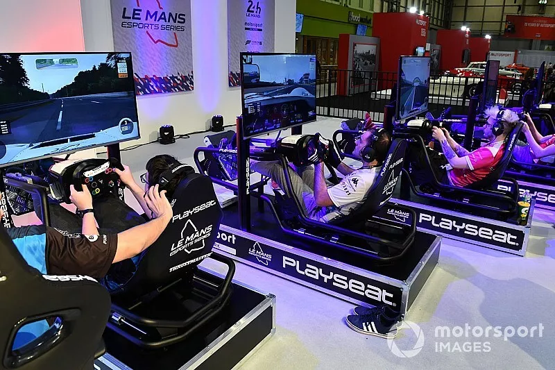 Fans enjoy the simulator rigs on the Le Mans eSports Series stand