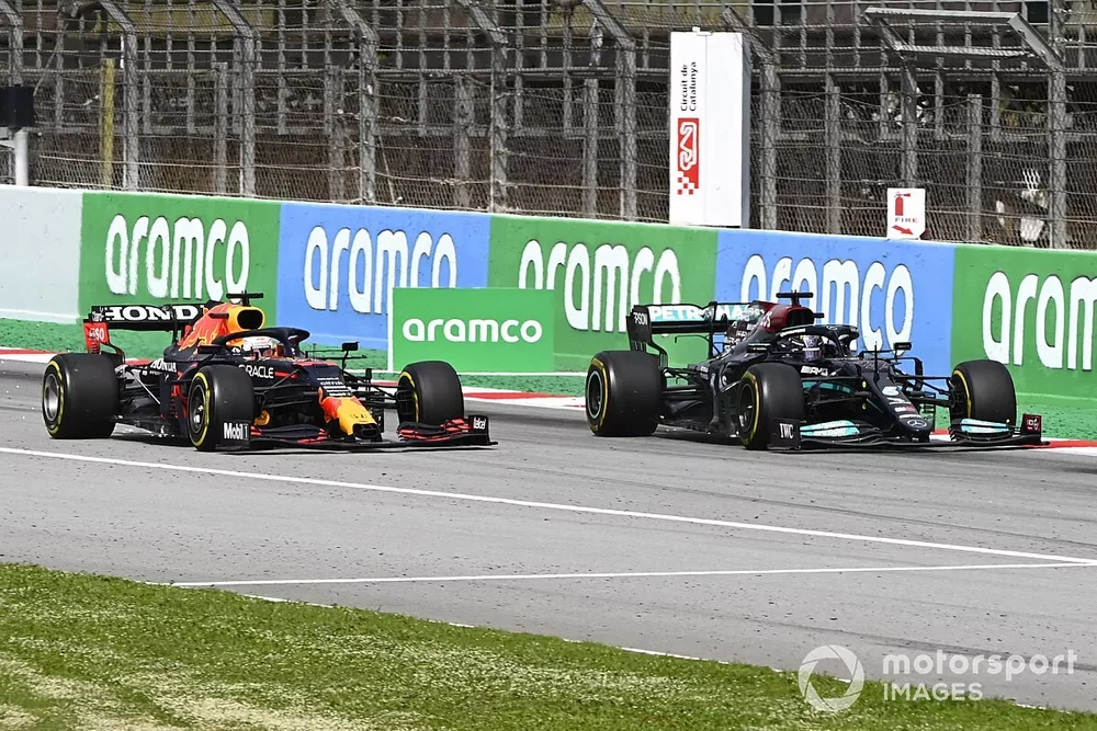 Lewis Hamilton, Mercedes W12, passes Max Verstappen, Red Bull Racing RB16B, for the lead