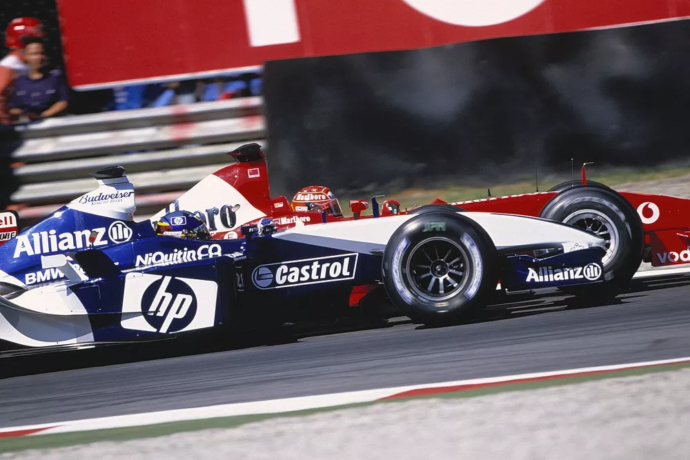 Michael Schumacher, Ferrari F2003 GA and Juan-Pablo Montoya, BMW Williams FW25, battling to gain first position