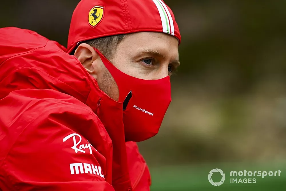 Sebastian Vettel, Ferrari walks the track on a bike