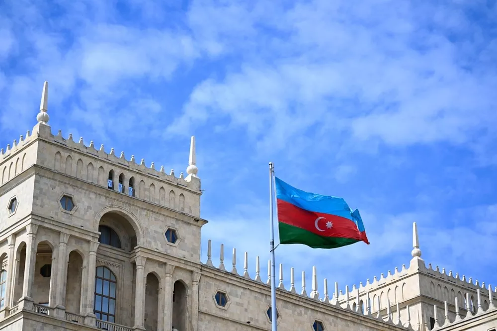 The Azerbaijan flag flies over buildings prior to final practice