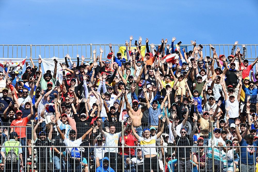 Fans wave from a grandstand