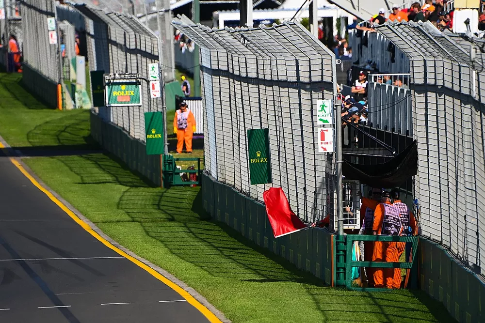 A marshal waves a red flag