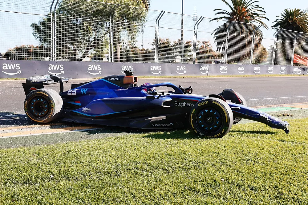 Alex Albon, Williams FW45, climbs from his car after a crash