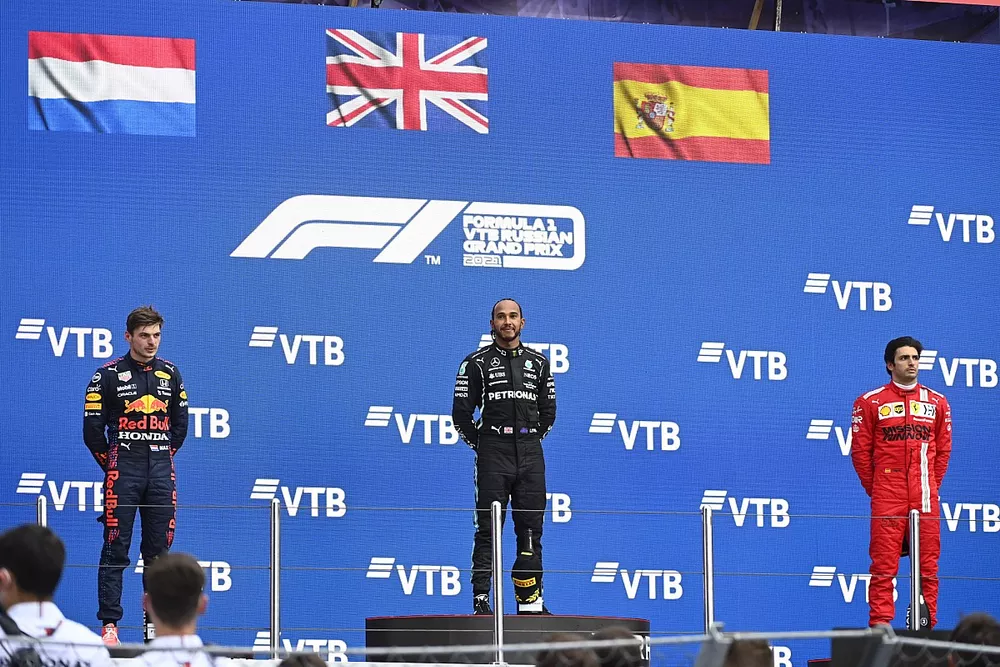 Max Verstappen, Red Bull Racing, 2nd position, Lewis Hamilton, Mercedes, 1st position, and Carlos Sainz Jr., Ferrari, 3rd position, on the podium