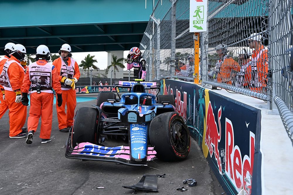 Marshals assist Esteban Ocon, Alpine A522, after a crash