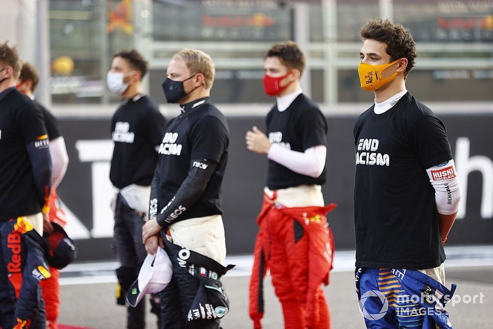 Lando Norris, McLaren, stands with the other drivers on the grid prior to the start