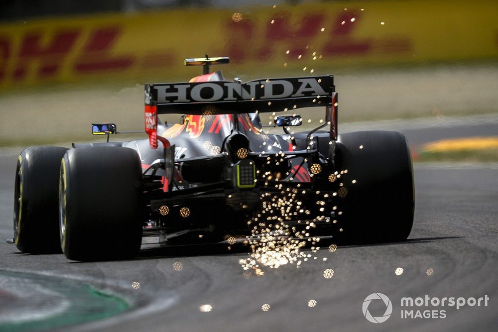 Sparks fly from the rear of Sergio Perez, Red Bull Racing RB16B