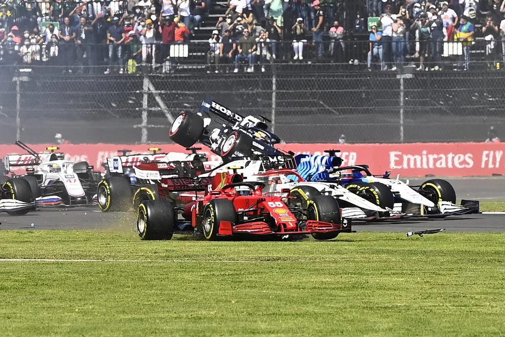 Daniel Ricciardo, McLaren MCL35M, Carlos Sainz Jr., Ferrari SF21, and George Russell, Williams FW43B, as Yuki Tsunoda, AlphaTauri AT02, gets airborne at the start