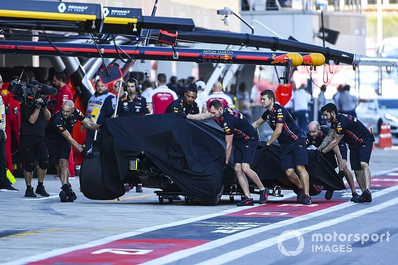 Red Bull mechanics wheel back the Alex Albon Red Bull RB15 in qualifying