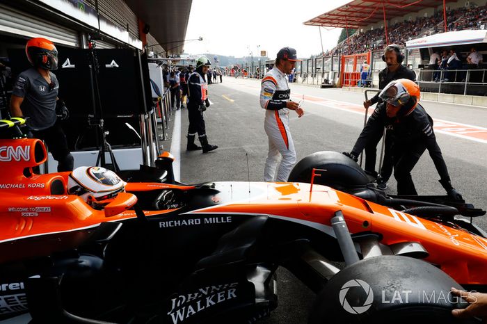 Stoffel Vandoorne, McLaren, is backed in to the garage as Fernando Alonso, McLaren, walks past