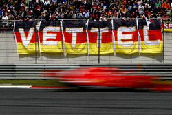 Sebastian Vettel, Ferrari SF71H, flashes past fans in a grandstand