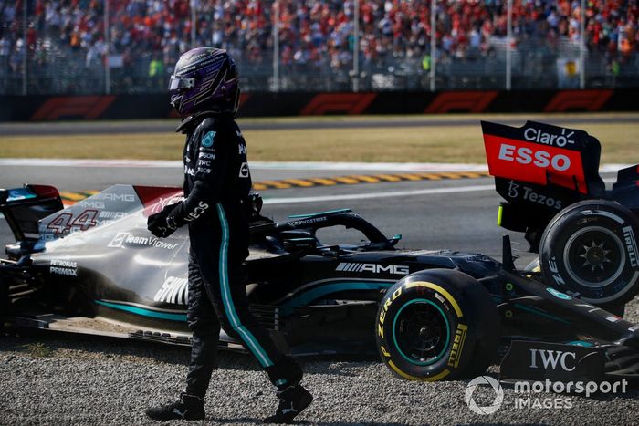 Lewis Hamilton, Mercedes, walks away after crashing out of the race with Max Verstappen, Red Bull Racing