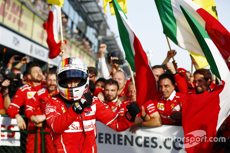 Sebastian Vettel, Ferrari, celebrates with his team after winning the race