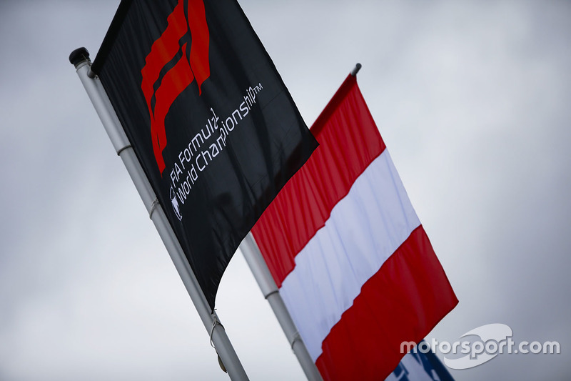 The Austrian flag flies alongside one displaying the Formula 1 logo