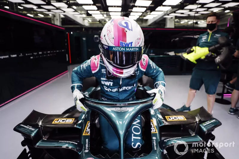 Sebastian Vettel, Aston Martin AMR21, climbs into his cockpit in the garage
