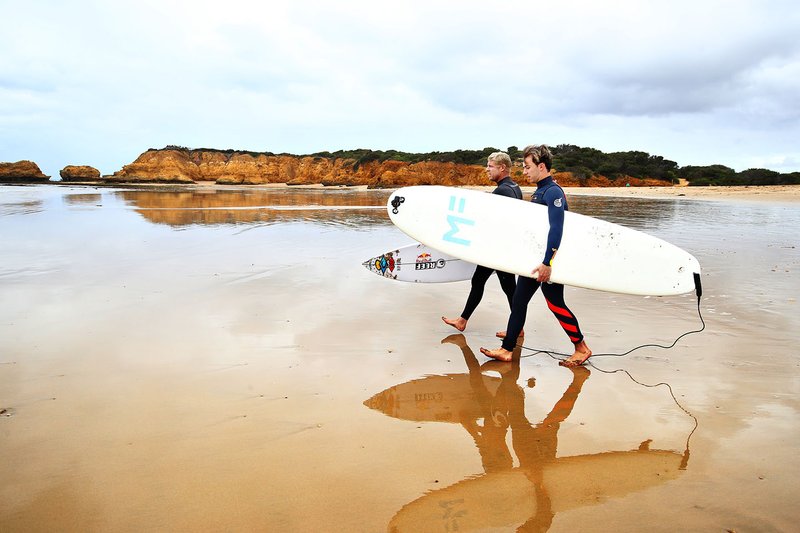 Pierre Gasly, Red Bull Racing poses for a photo after surfing with surf legend Mick Fanning