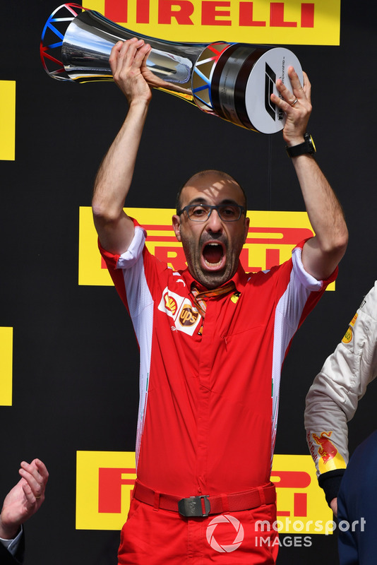 Carlo Santi, Ferrari Race Engineer celebrates on the podium with the trophy